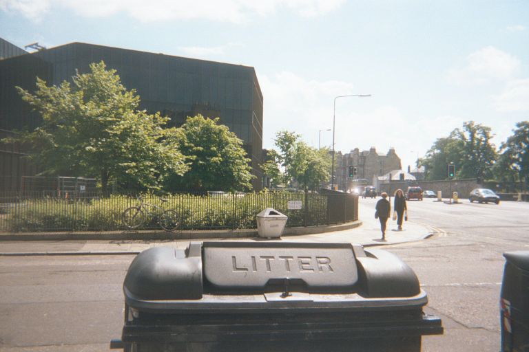 
I shot this because I thought it was neat to  have the super-old castle 
building in the background and a modern building in the foreground.
But a litter basket got there, too.
