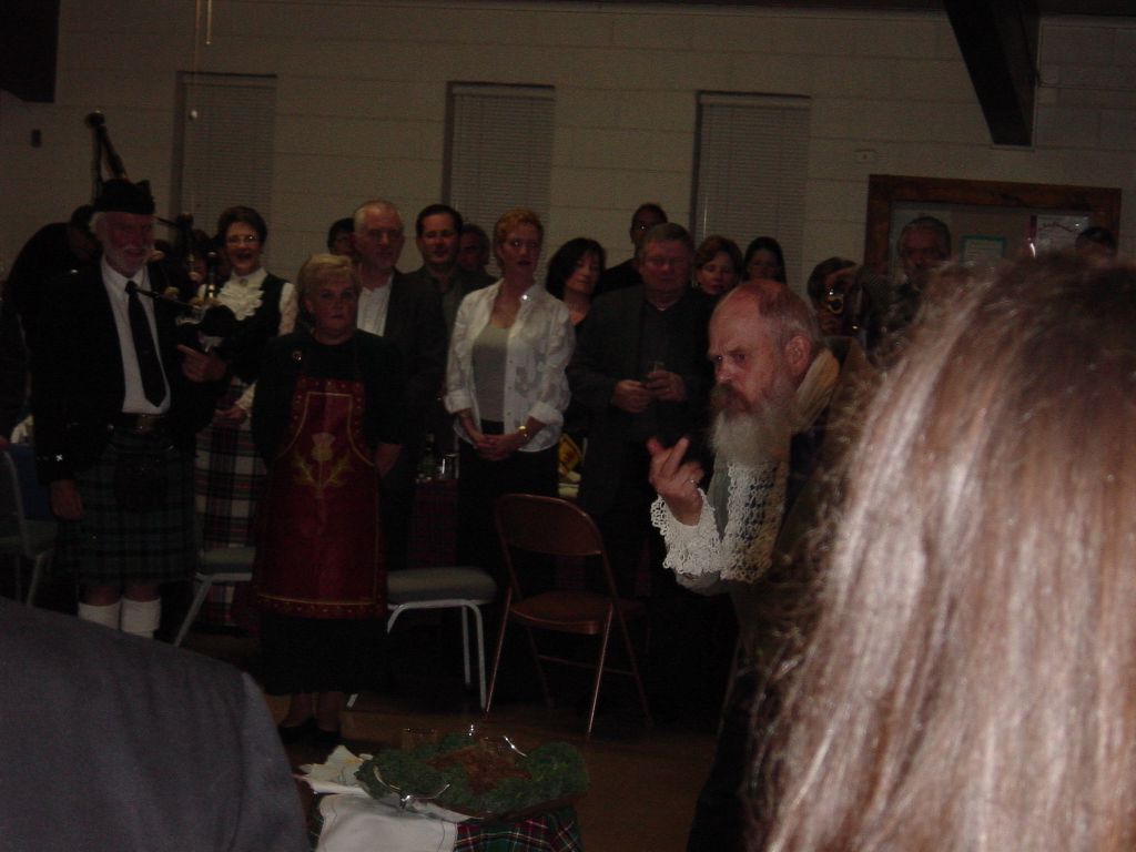 

Pictures from the Robert Burns Supper in Austin, TX, 2004.

Addressing the haggis.  No, he is not giving the haggis the finger.

